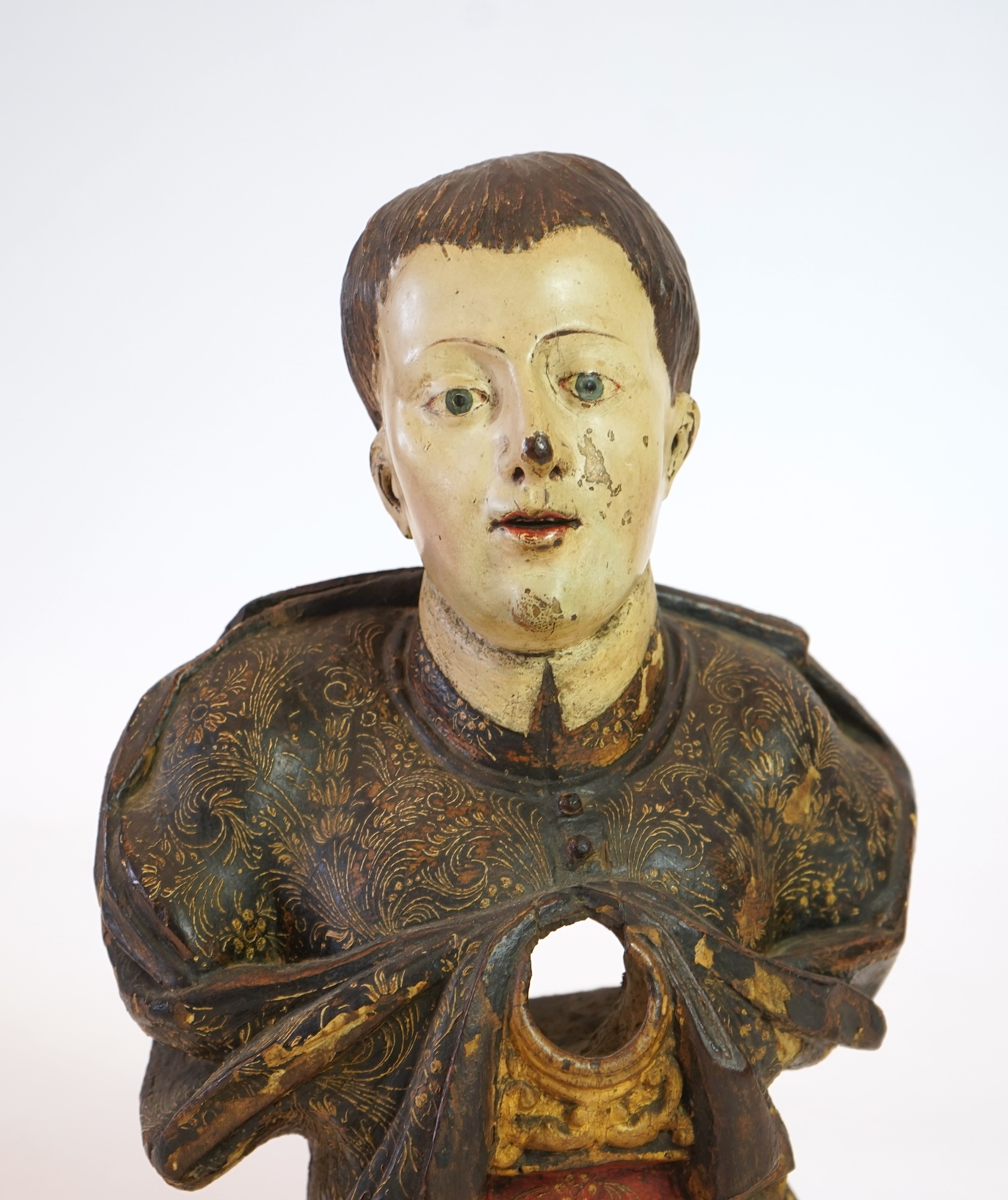 A 19th century Spanish polychrome wood bust of a Saint